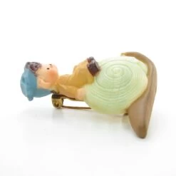 Pixie Boy Sitting On A Snail Vintage Hallmark Lapel Pin -Toy Store Boy on snail hallmark decorative pixie pin